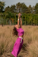 Woman gently stretching outdoors during sunrise, embodying rebound movement.