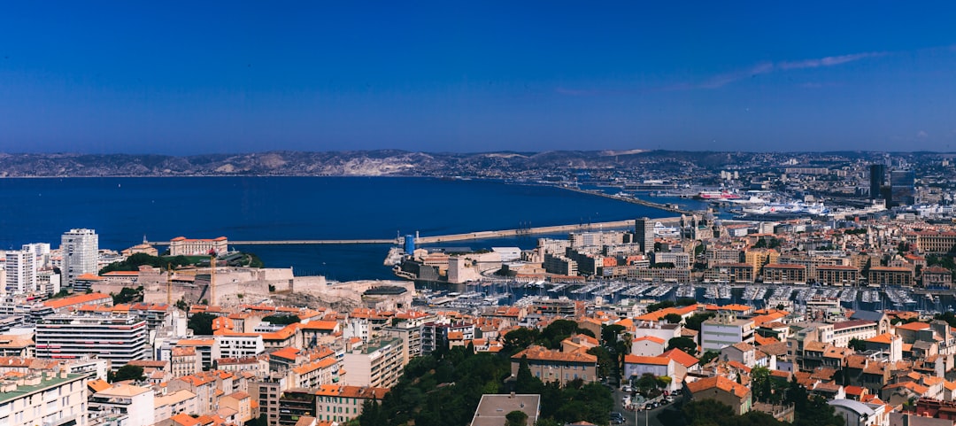 a city with a body of water in the background,