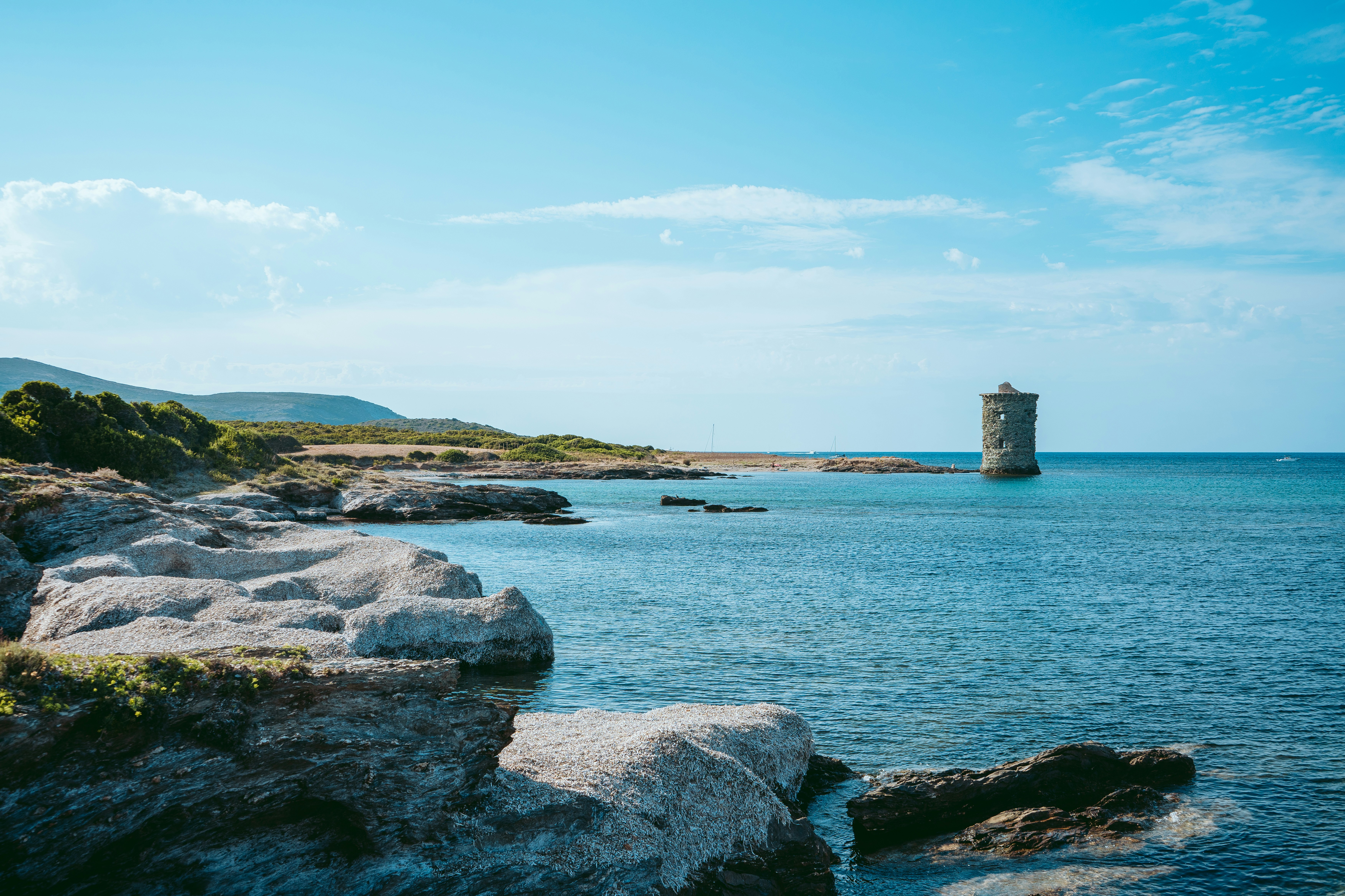 a rocky beach with a tower