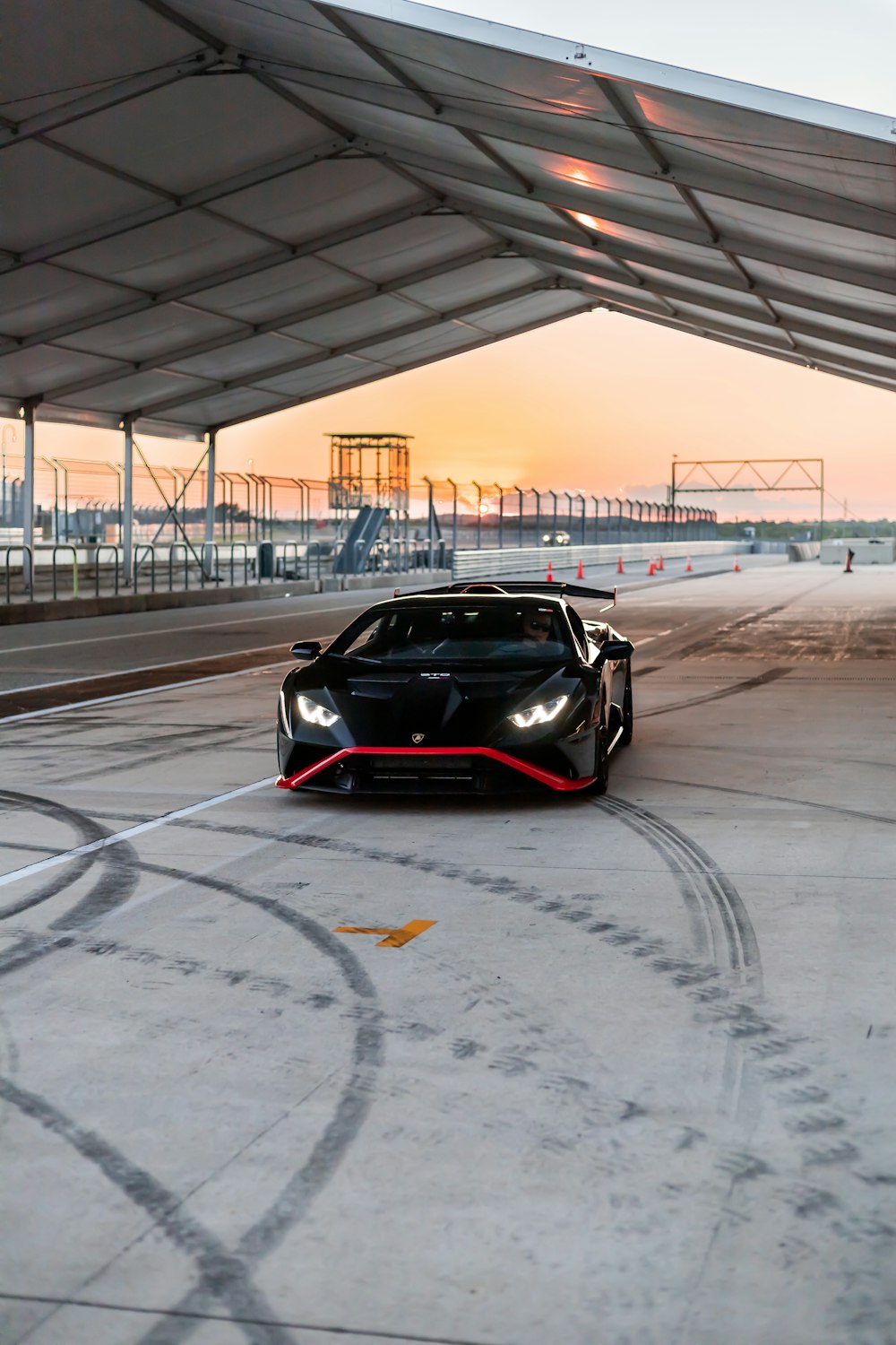 a black car parked under a covered area