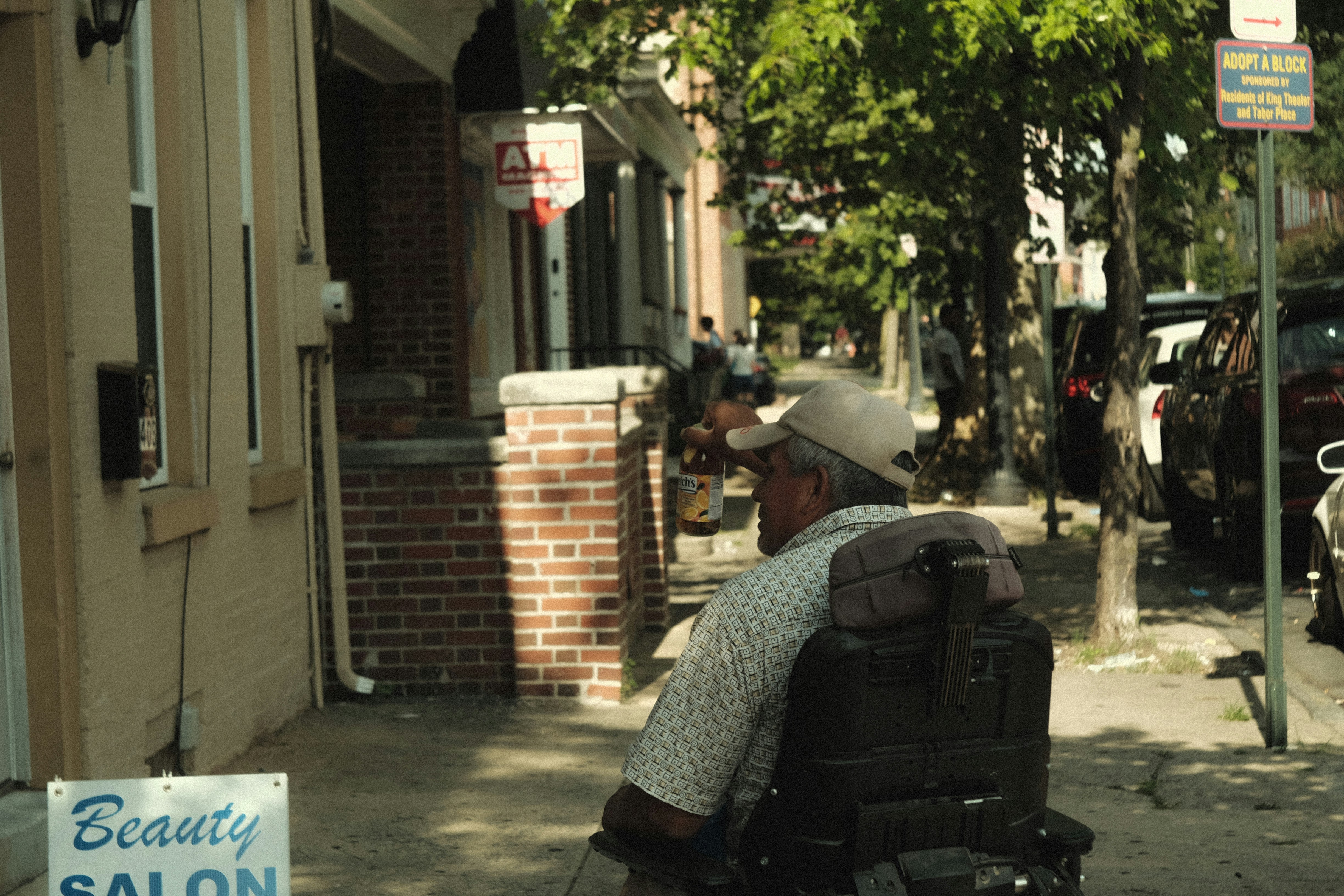 a person sitting on a sidewalk