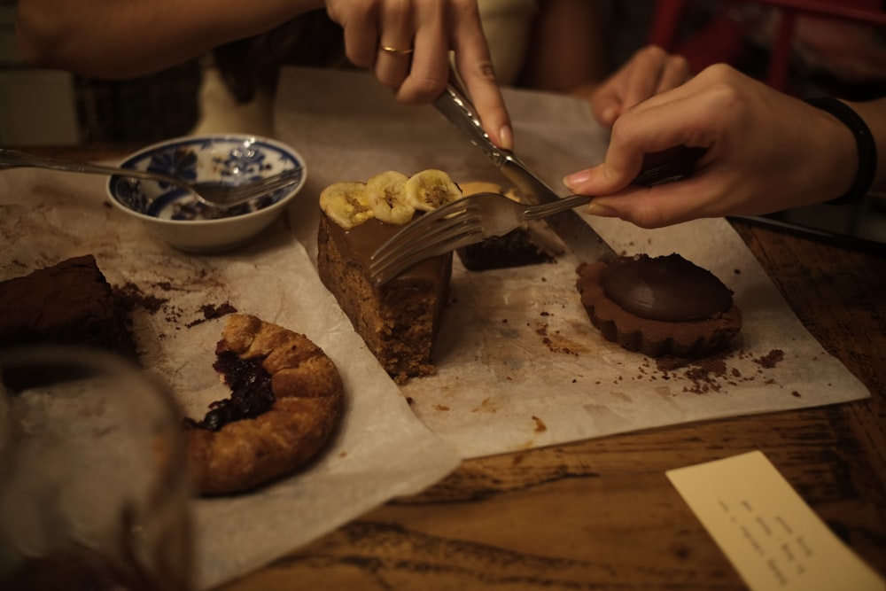 a person cutting a cake with a knife