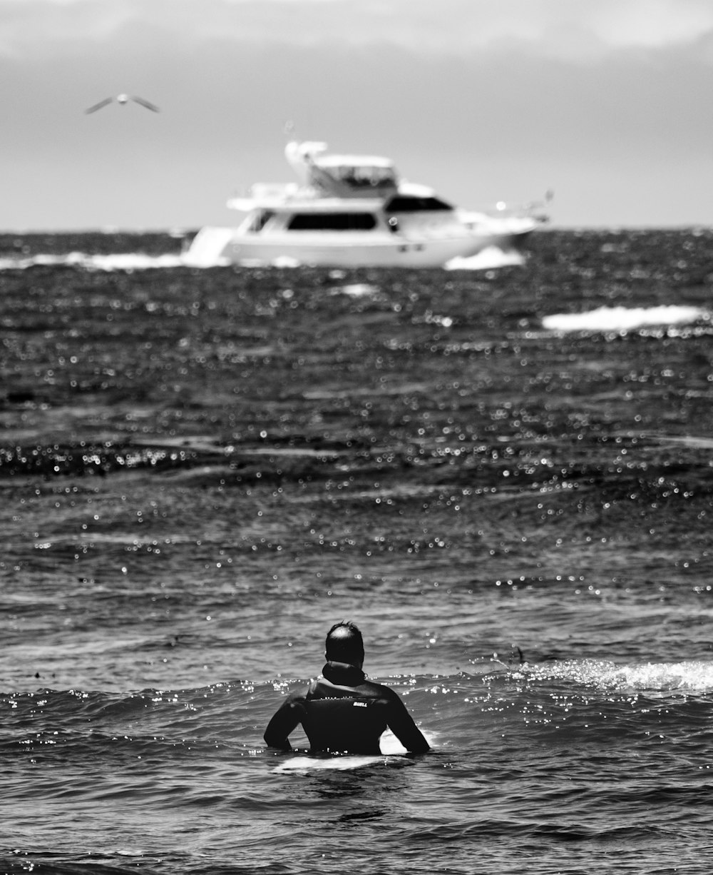 a person in the water with a plane in the background