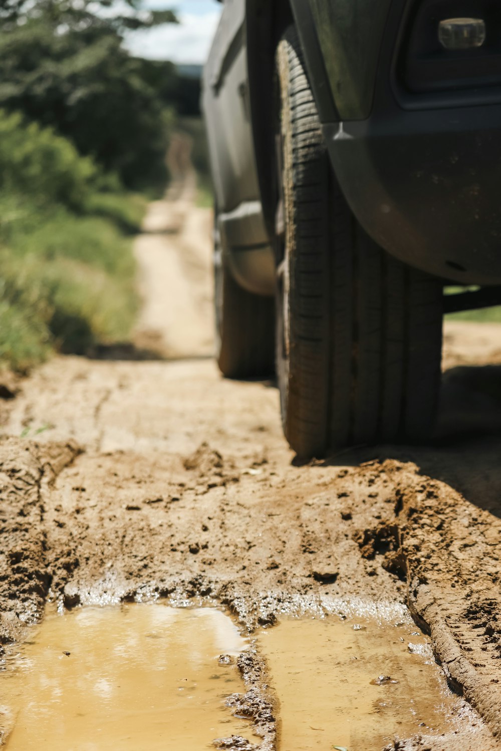 a car is parked in a muddy lot