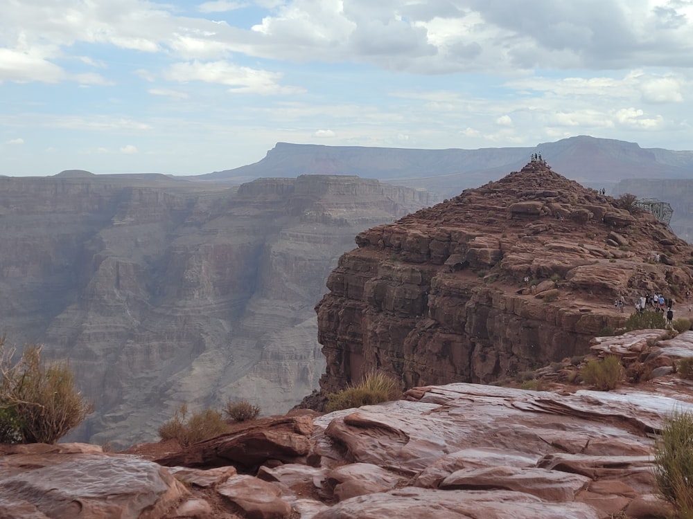 a rocky canyon with people walking on it