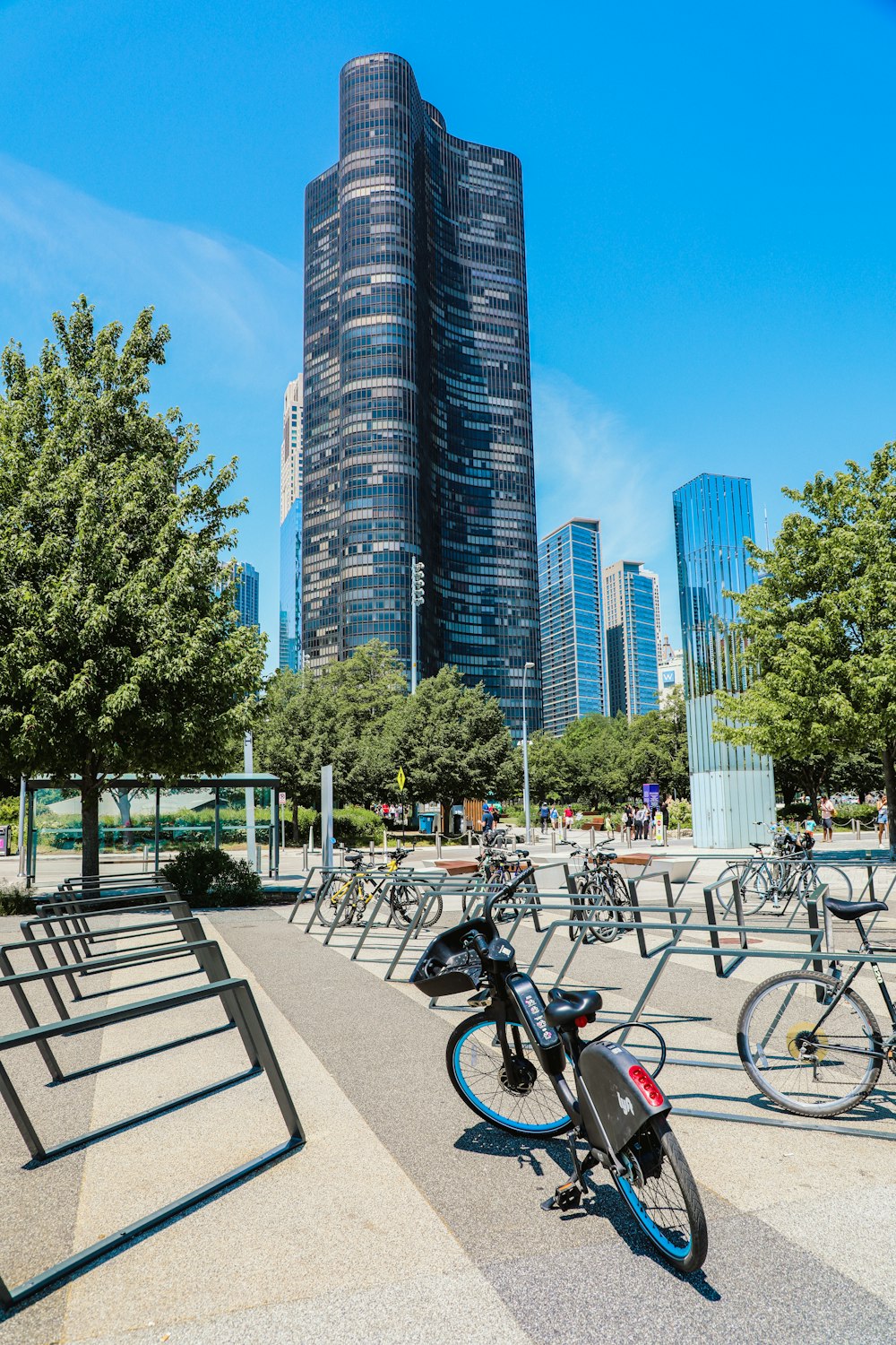 a group of bicycles parked in front of a tall building