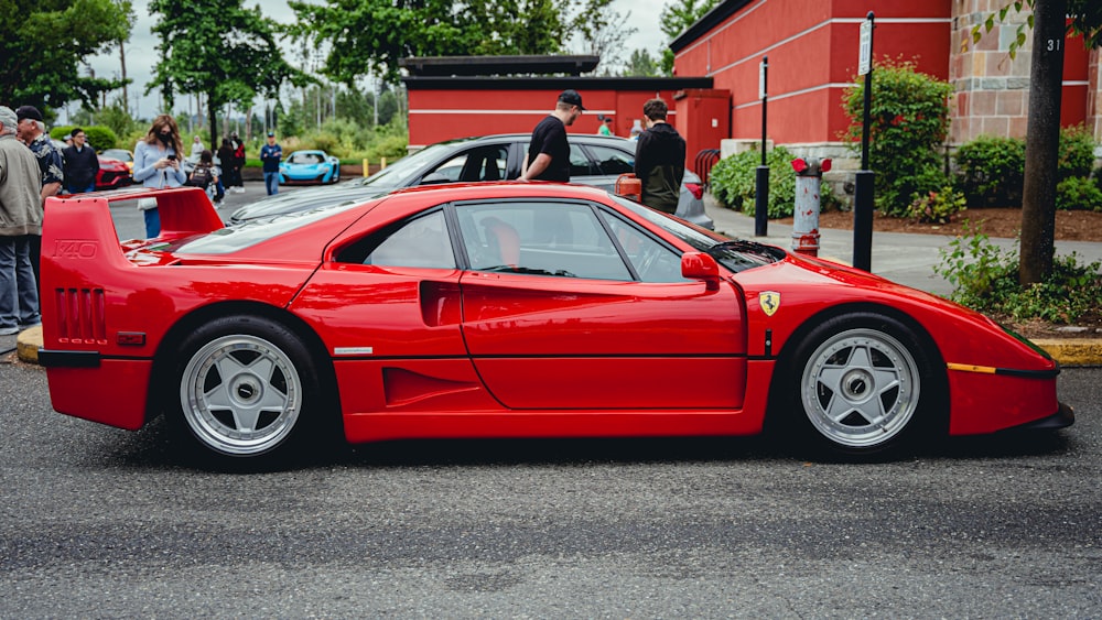 a red sports car parked on the side of a road