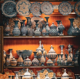 a shelf with many vases on it