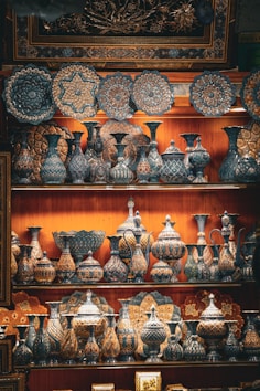 a shelf with many vases on it