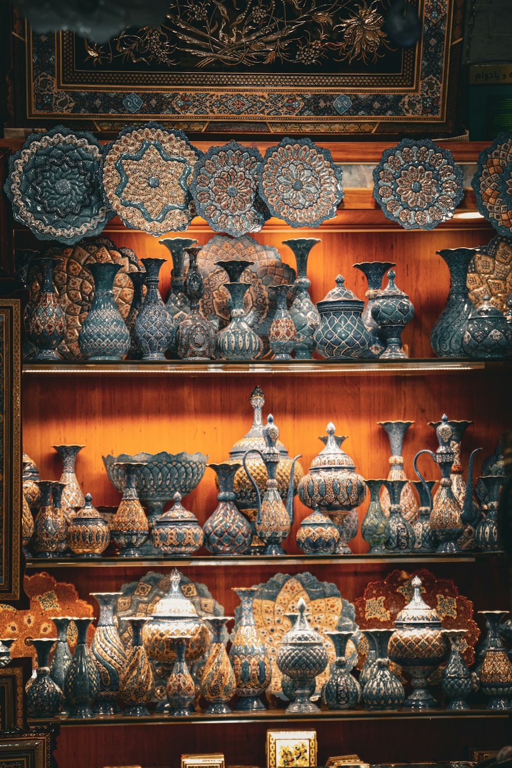 a shelf with many vases on it