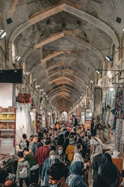a large group of people in a room with many clothes