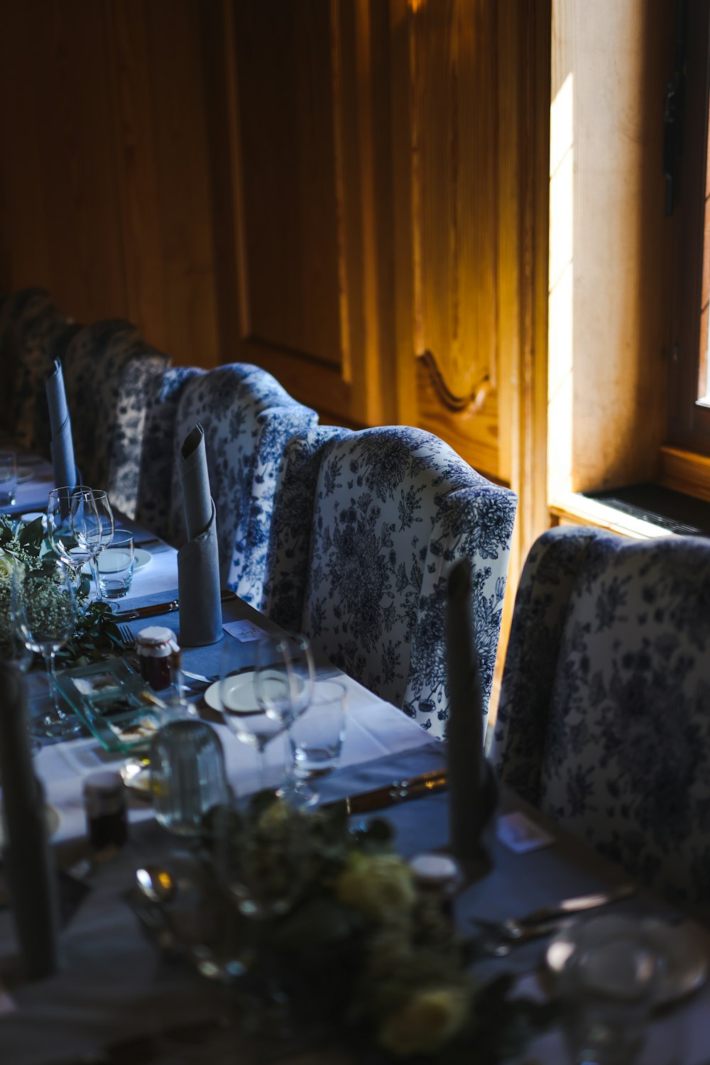 a table with a glass and a chair with a plant on it