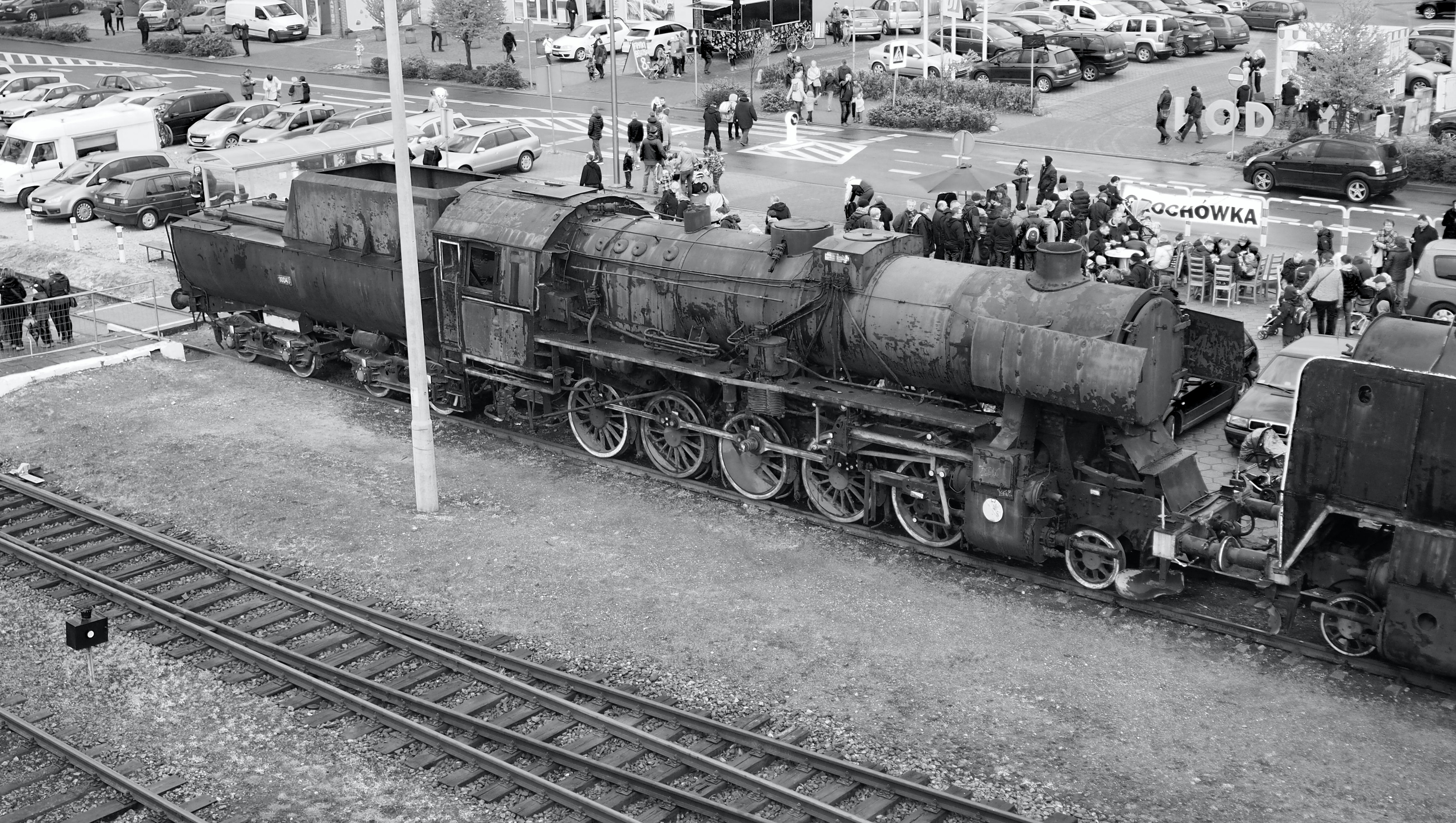 a black and white photo of a tank on a train track