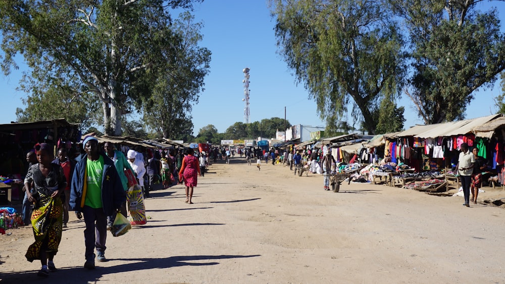 people walking on a dirt road