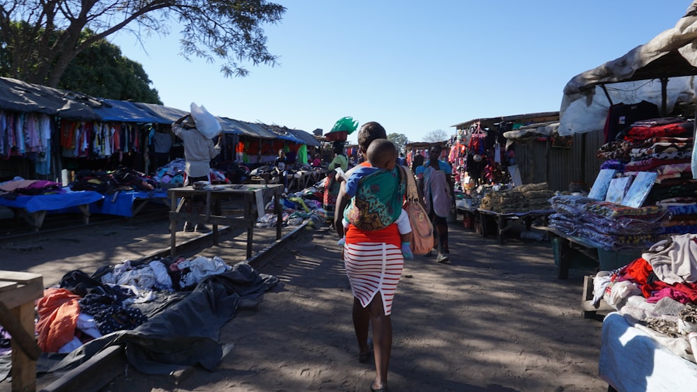 a couple of people walking in a market