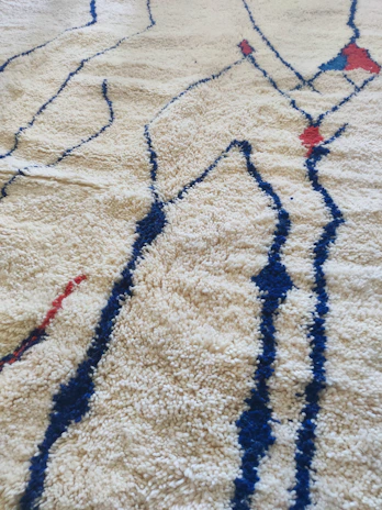 Detailed shot of a logo rug with crisp lines and deep terracotta hues.