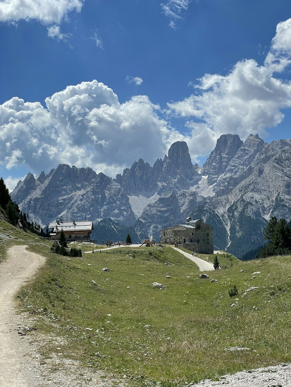 a building on a hill with mountains in the background