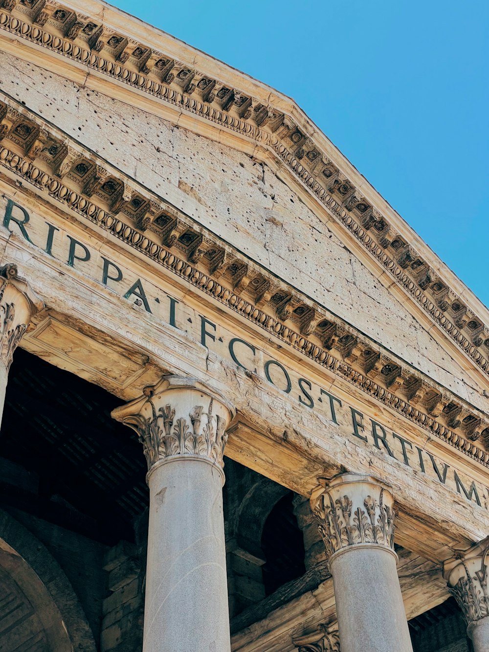 a building with columns and a sign