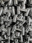 A collection of steel fittings displayed on a wooden table.