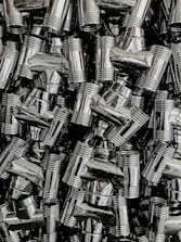 Rows of shiny sanitary pipes and connectors displayed in store.