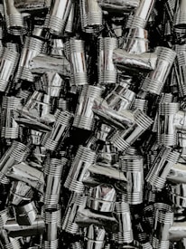 Rows of shiny brass components neatly arranged on a factory shelf, ready for shipment.
