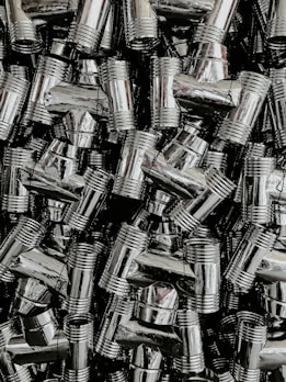 Colorful assortment of plastic and metal pipe fittings displayed neatly.