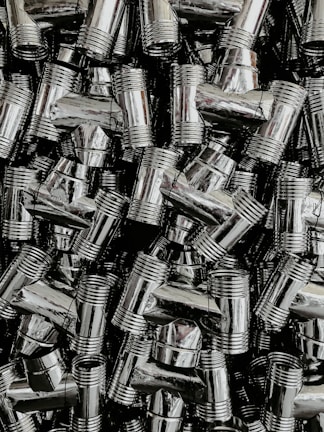 Rows of shiny plumbing pipes and fittings displayed on wall racks.