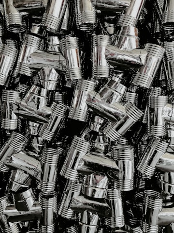 Rows of shiny brass components neatly arranged on a factory shelf, ready for shipment.