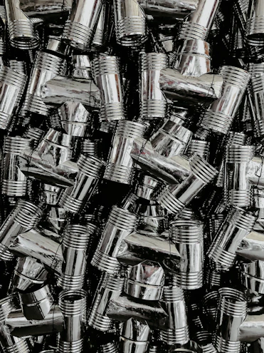 Close-up of shiny plumbing pipes and fittings laid out on a clean surface.