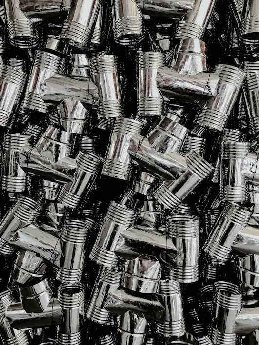 A close-up of shiny new plumbing pipes and fittings neatly arranged on a wooden surface.