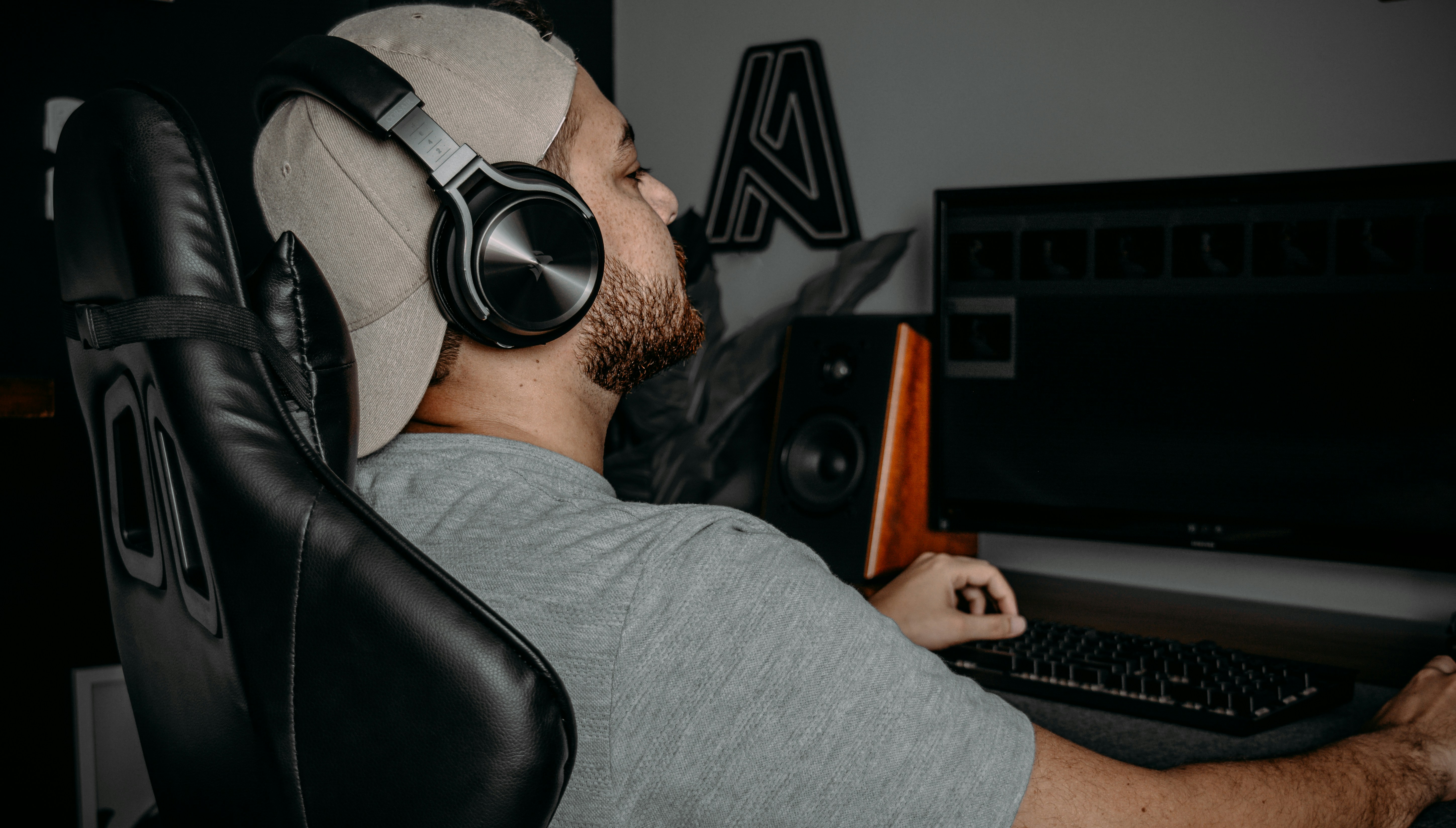 a person wearing headphones and sitting at a computer