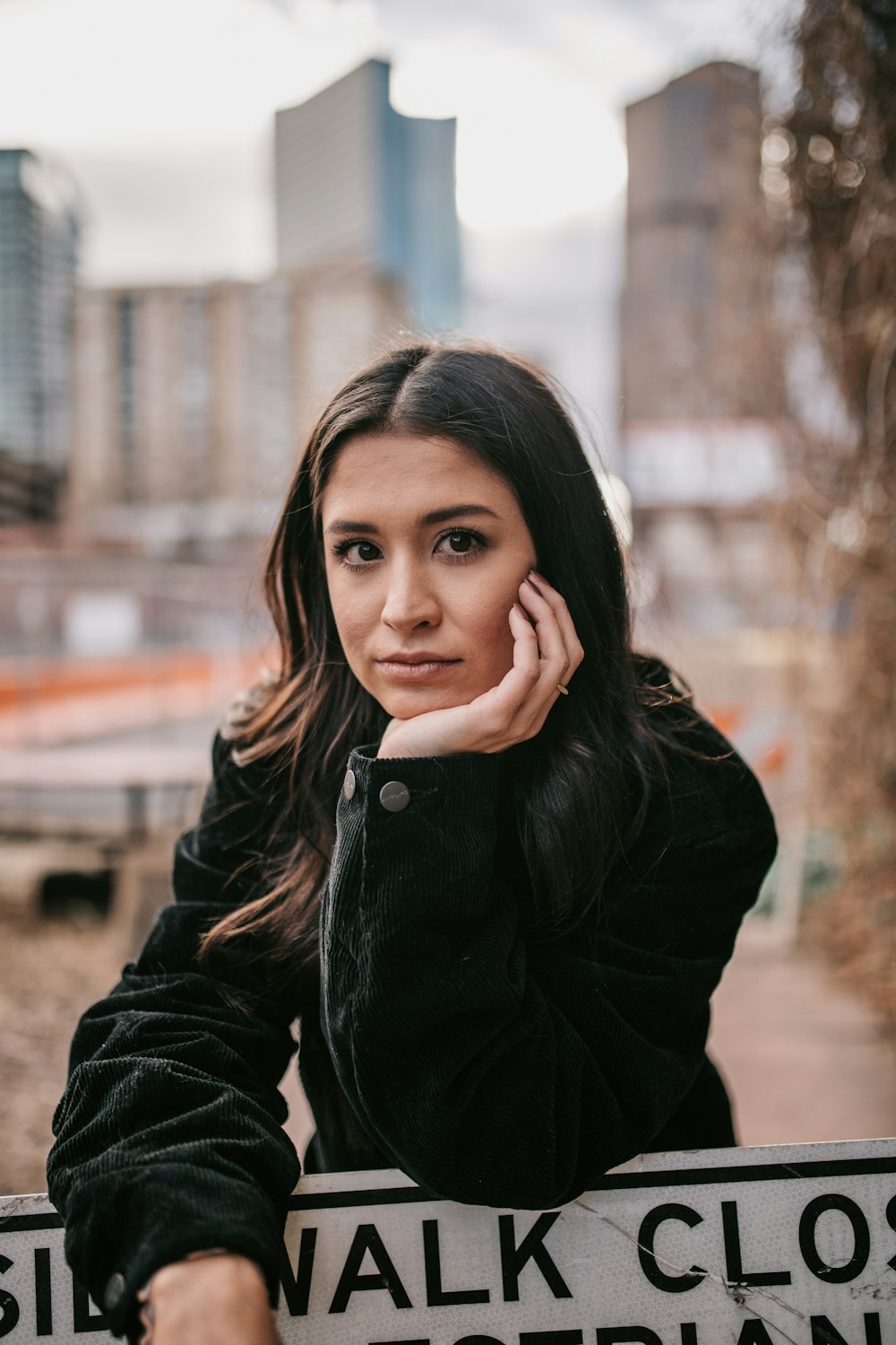 a woman with her hand on her face