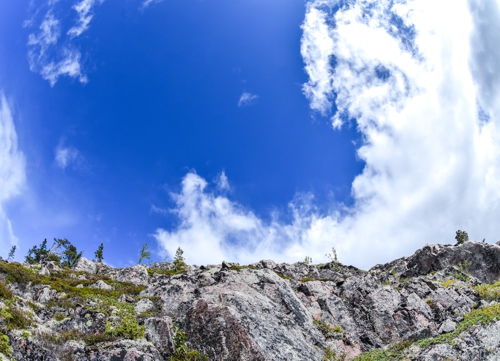 a rocky hillside with clouds