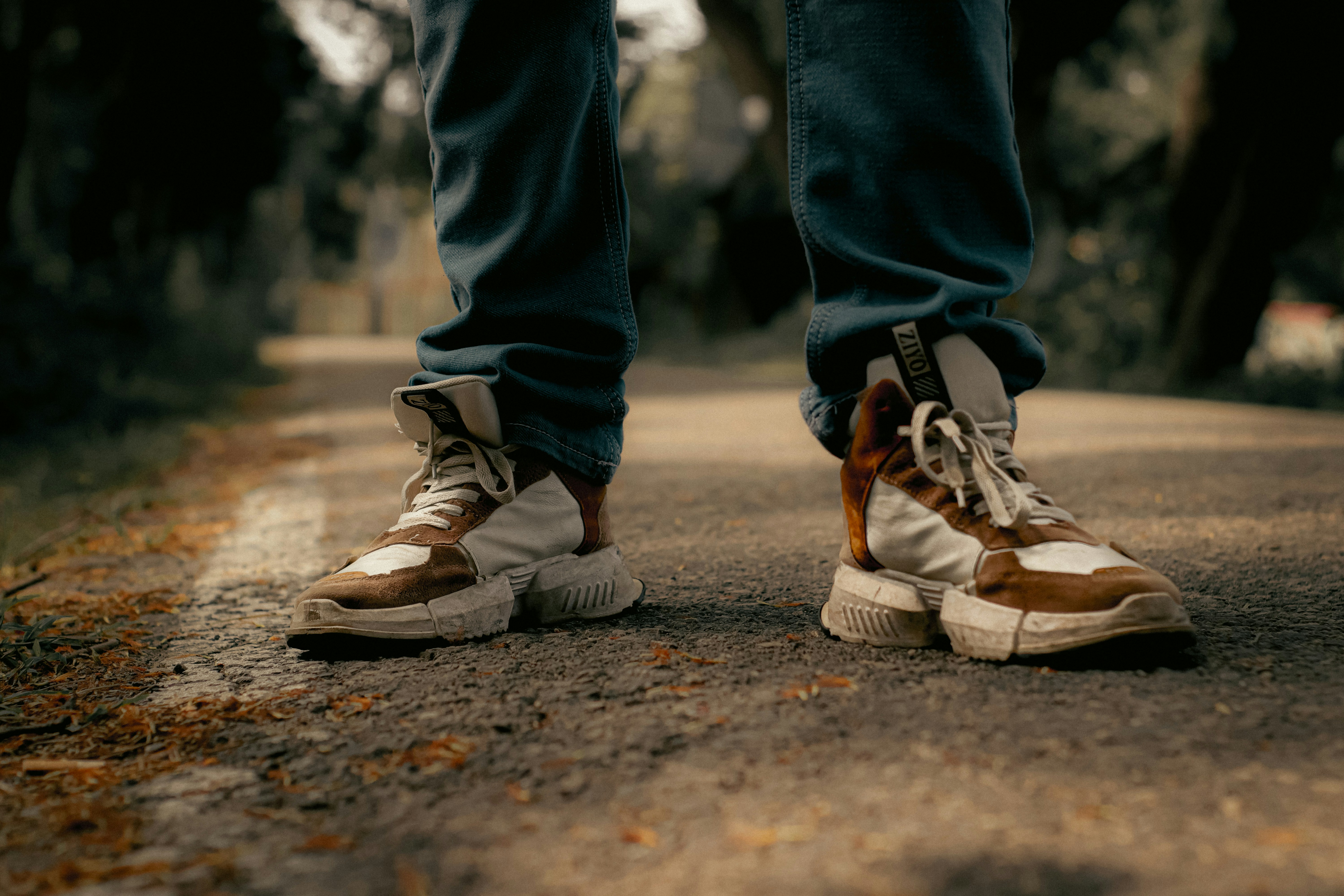 a pair of legs wearing brown shoes