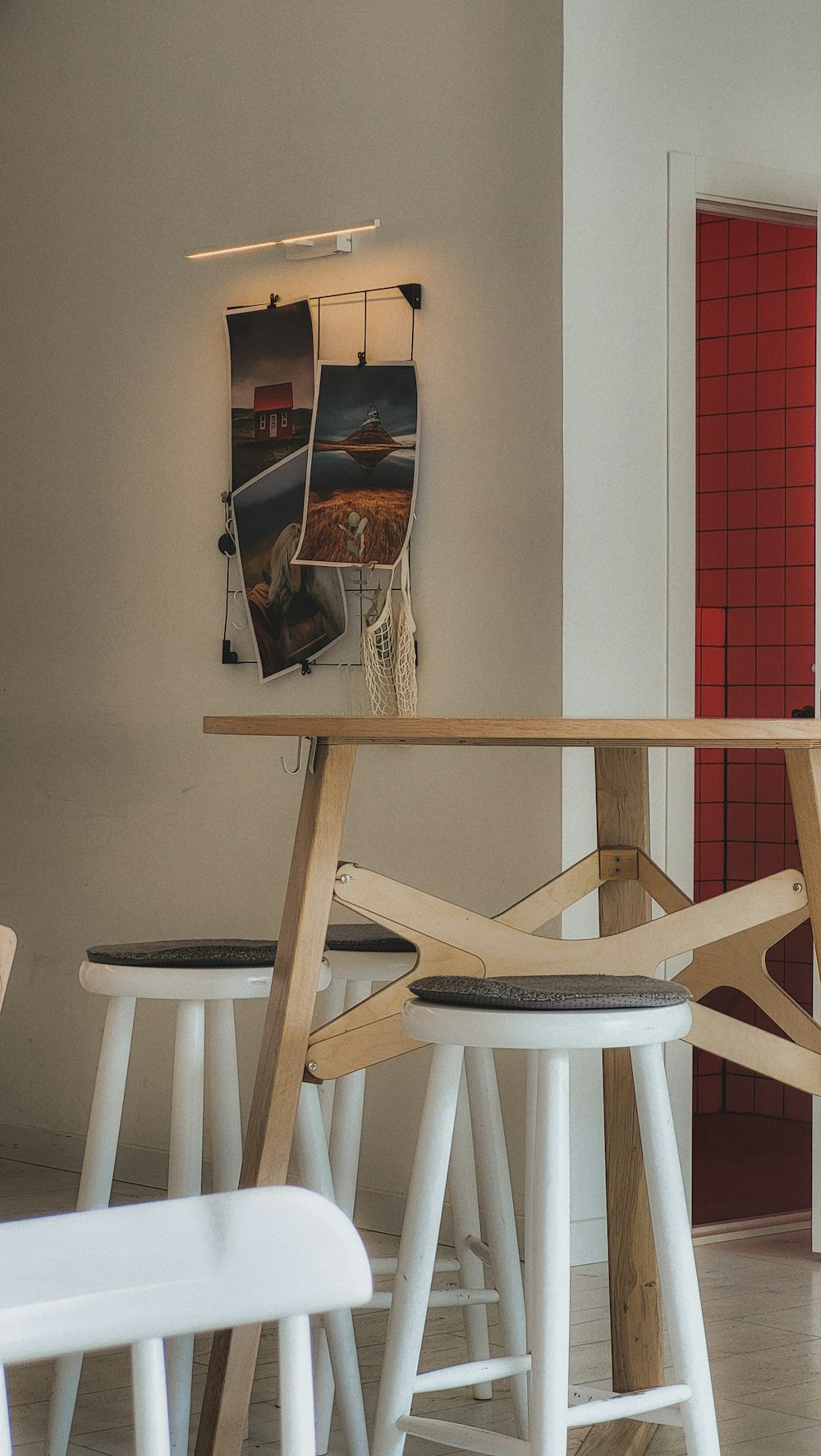 a table with stools and a shelf with objects on it