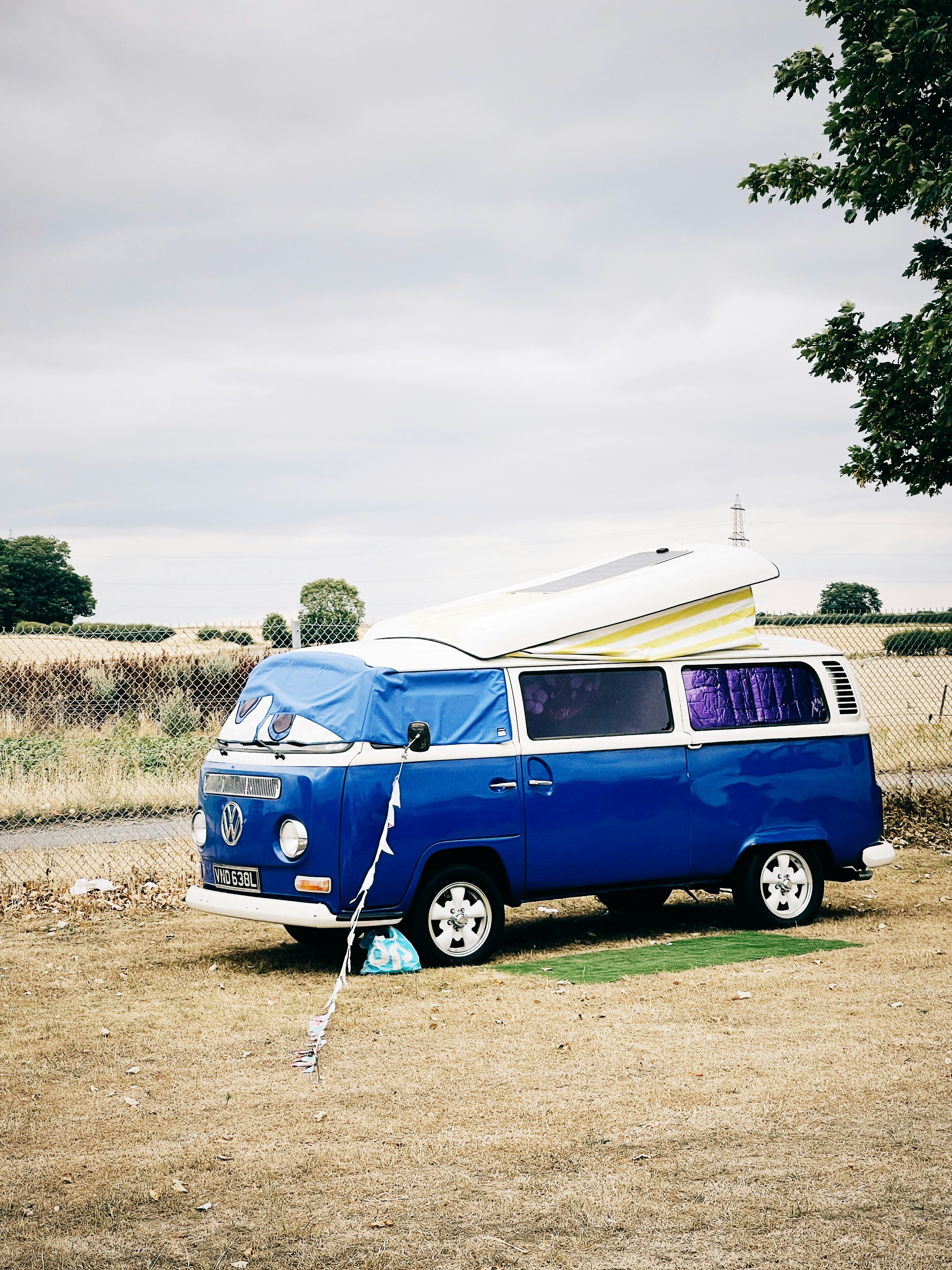 a blue van with a white canopy