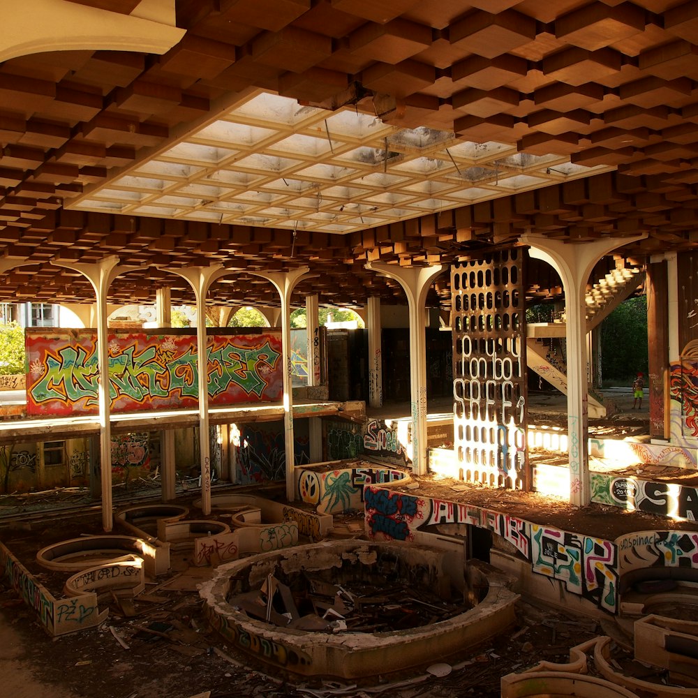 a large room with a fountain and benches