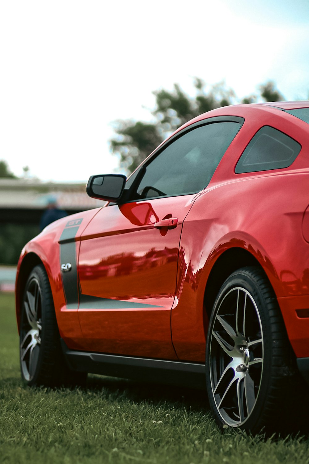 a red car parked on grass