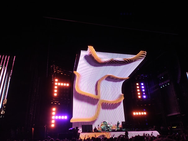 A vibrant LED stage setup glowing with dynamic colors at a live concert.