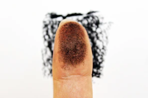 Close-up of a forensic expert carefully dusting for fingerprints at a crime scene.