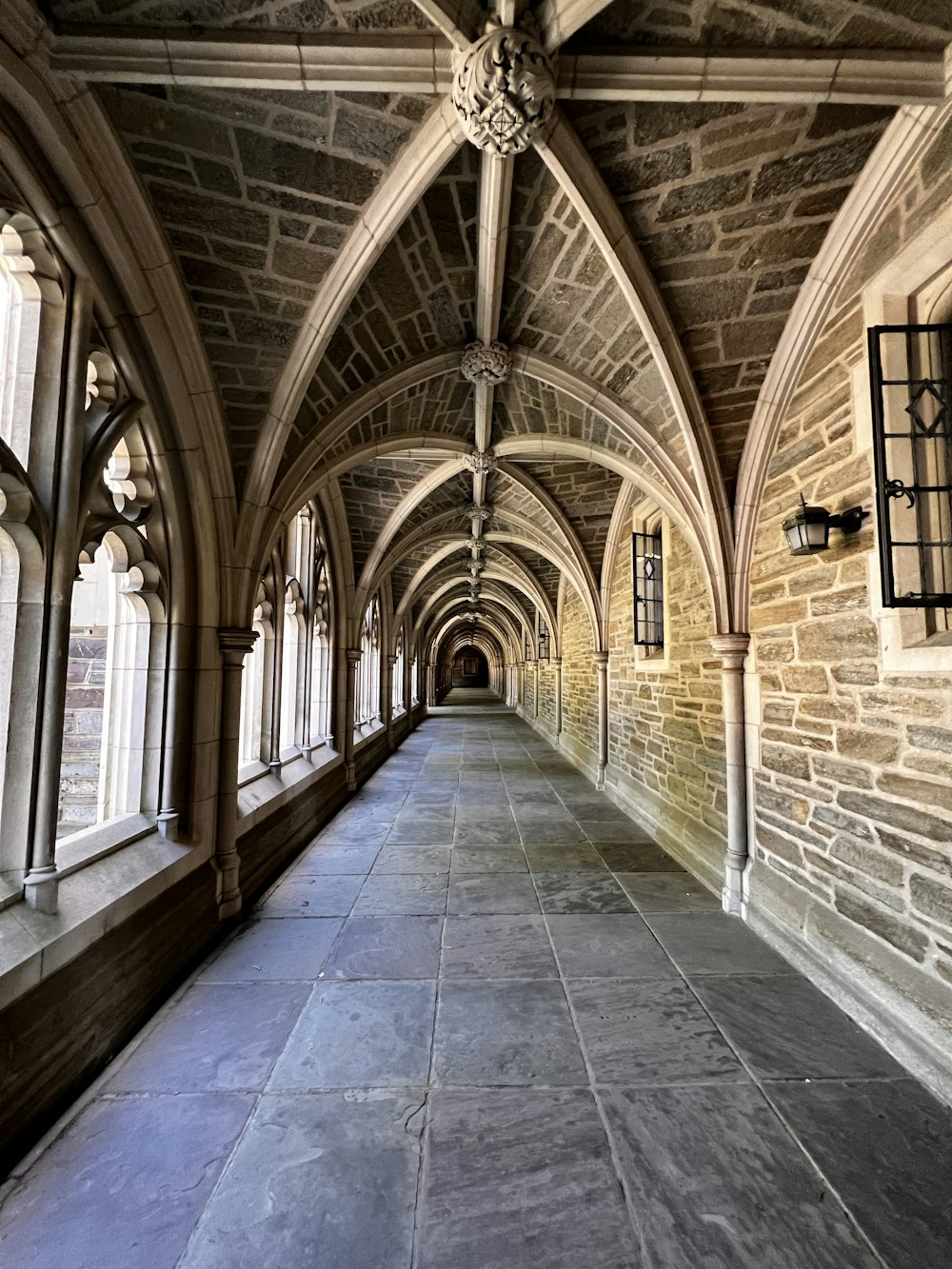 a stone walkway with arched windows