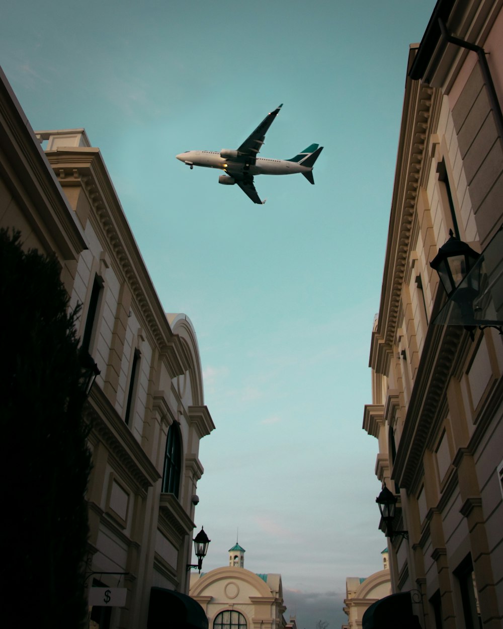 an airplane flying over buildings
