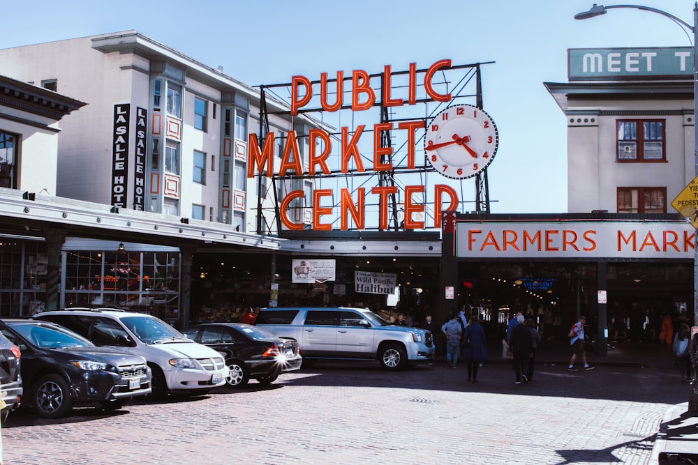 a group of people outside of a store with Pike Place Market in the background