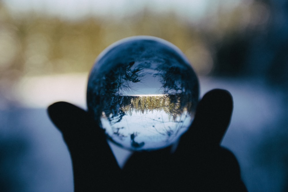 a hand holding a glowing globe