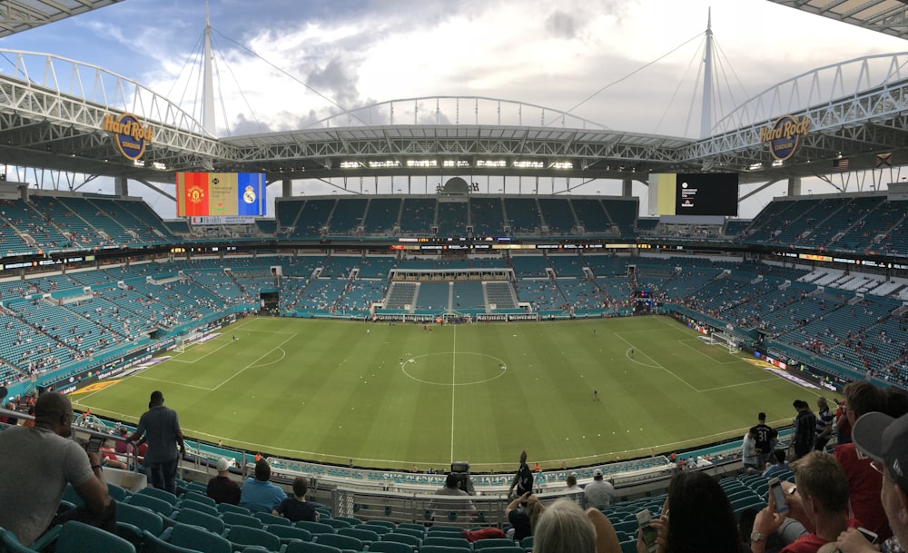 a sports stadium with a green field