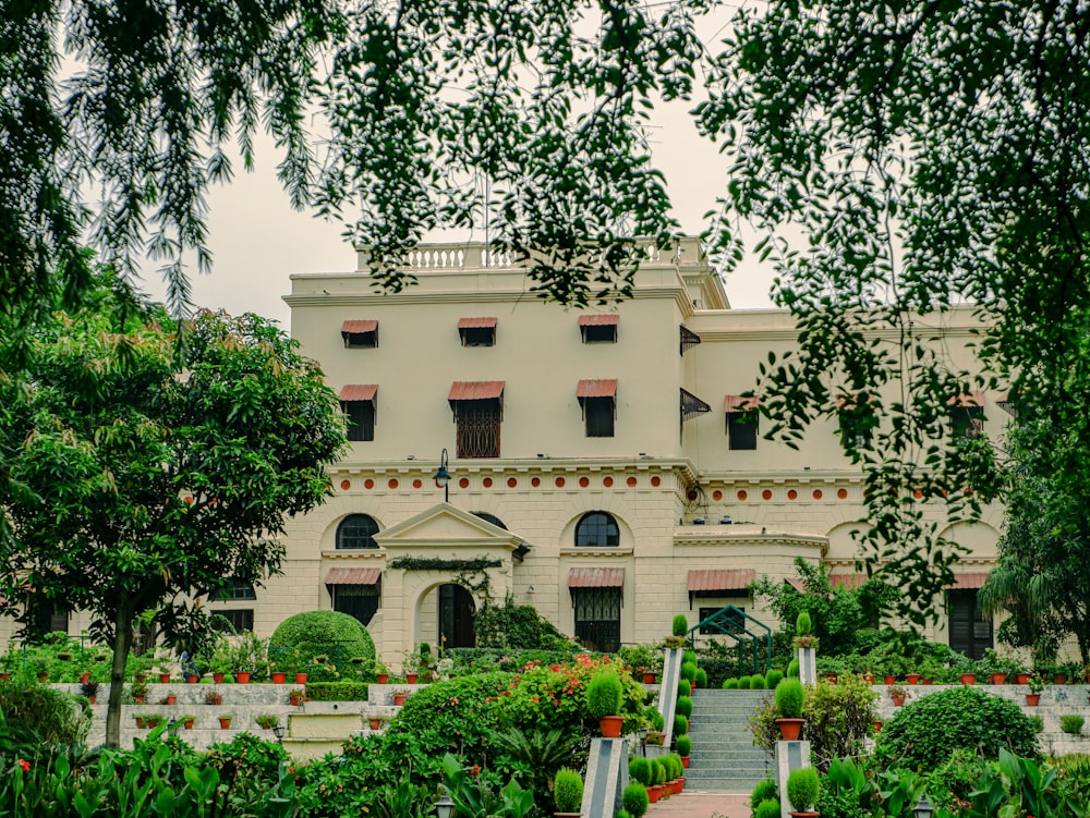 a building with trees and plants in front of it