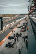 Action shot of the kart team preparing the karts in the pit lane.