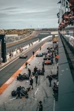 a group of people around a race car on a track