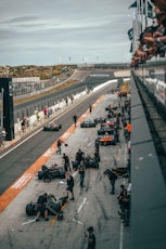 a group of people around a race car on a track