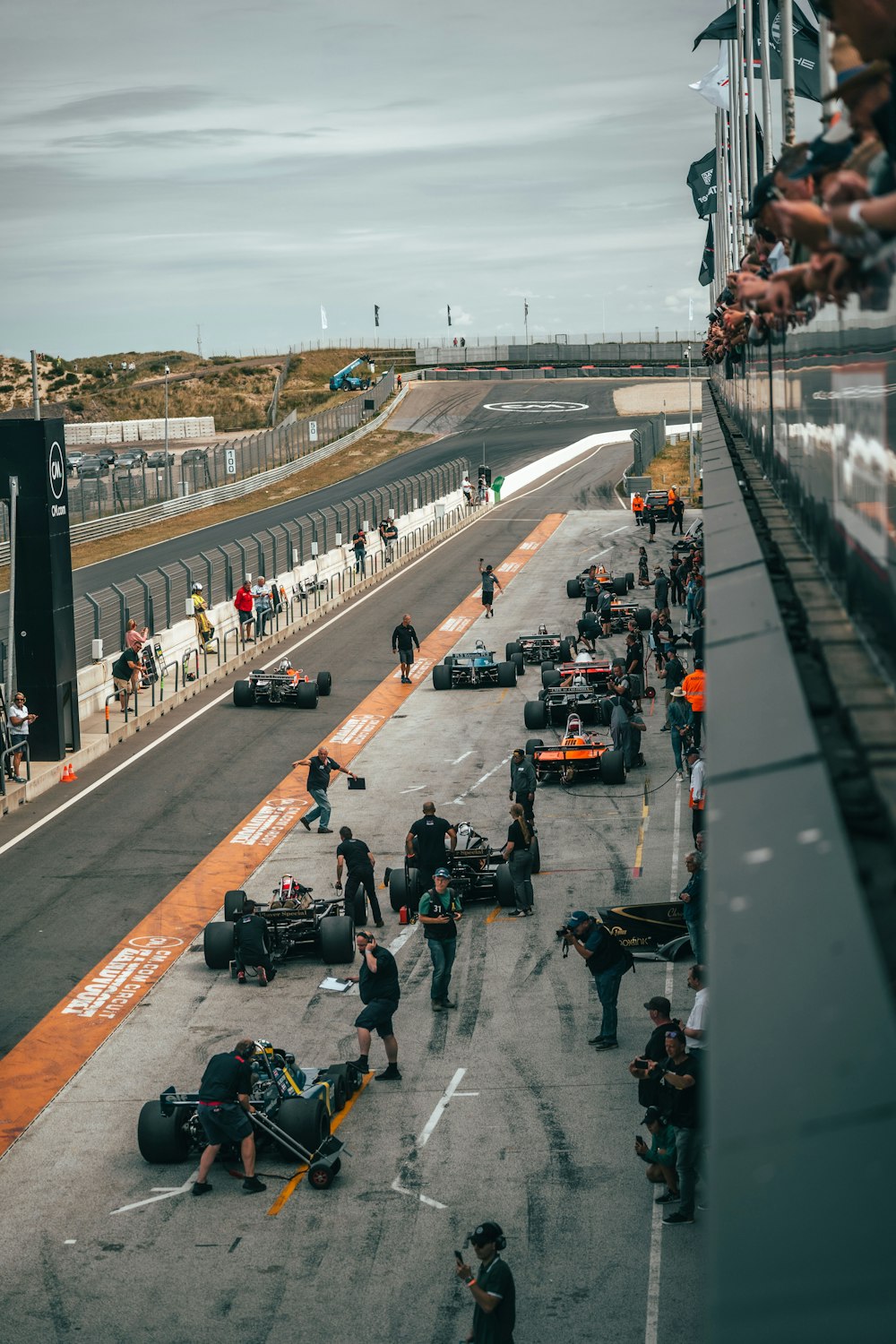 a group of people around a race car on a track